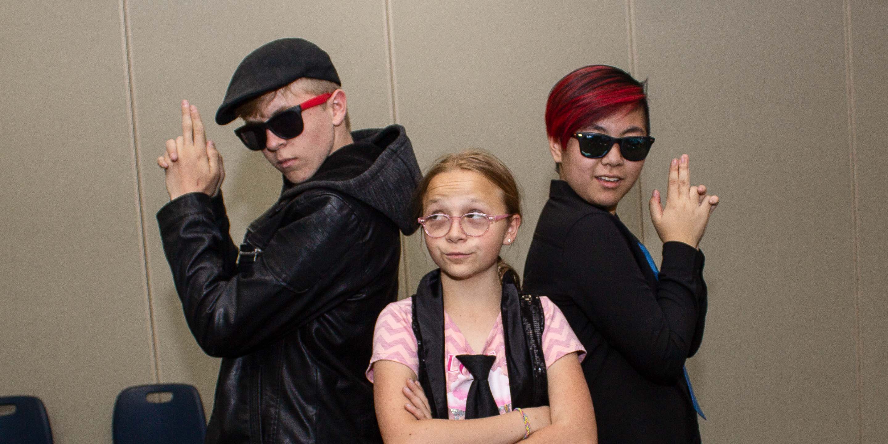 Three kids acting pretending to be spies